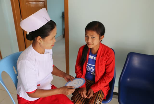 Midwife Nan Win Phyu at the Nam Khoke rural health center uses the family planning wheel to explain contraceptive options. Photo credit: UNFPA.