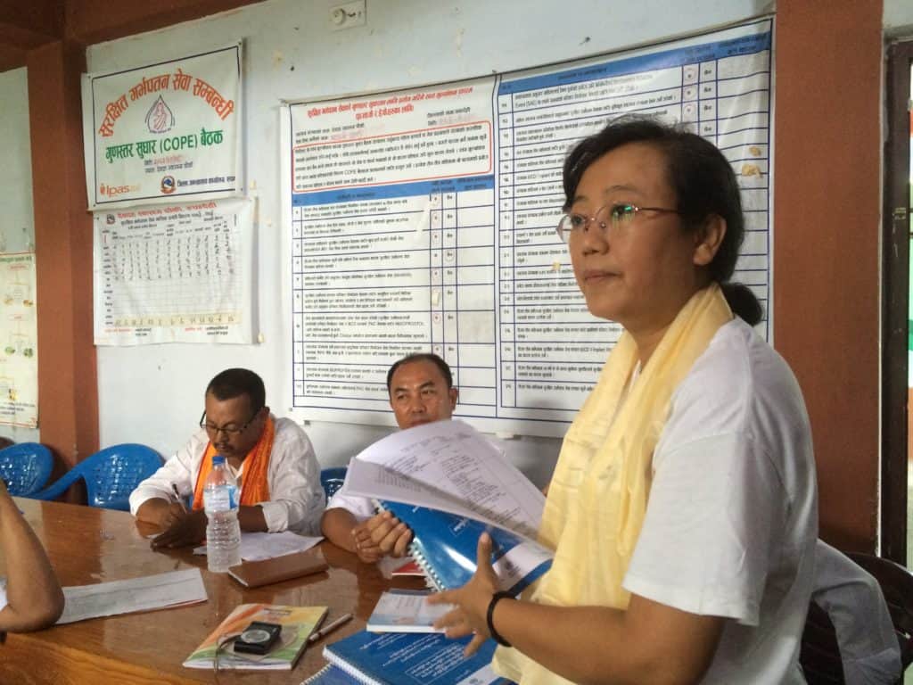 Dr. Aye Aye Thet from JSI/Myanmar shares Integrated Management of Neonatal and Childhood Illness program materials from Myanmar at a health post in Nepal. Photo Credit: Penny Dawson, JSI/CNCP.