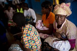 Above: A woman breastfeeds her baby in the waiting room of a hospital in Buchanan, Liberia. (Kate Holt/Jhpiego)