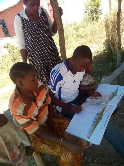 Above: CHWs using the community register to actively trace children who are due for the MCV2 vaccine.