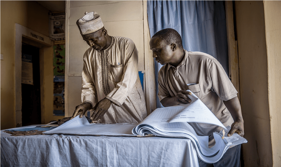 Health workers in Nigeria look over their Immunization records. Photo by Karen Kasmauski/MCSP.