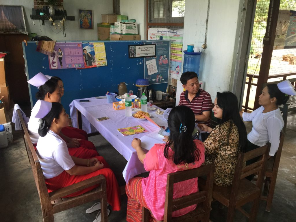 JSI staff Zar Ni Soe and Tin Moe Aung conduct a site visit in Wundwin, Mdy region to help health workers analyze data at the local medical center. 