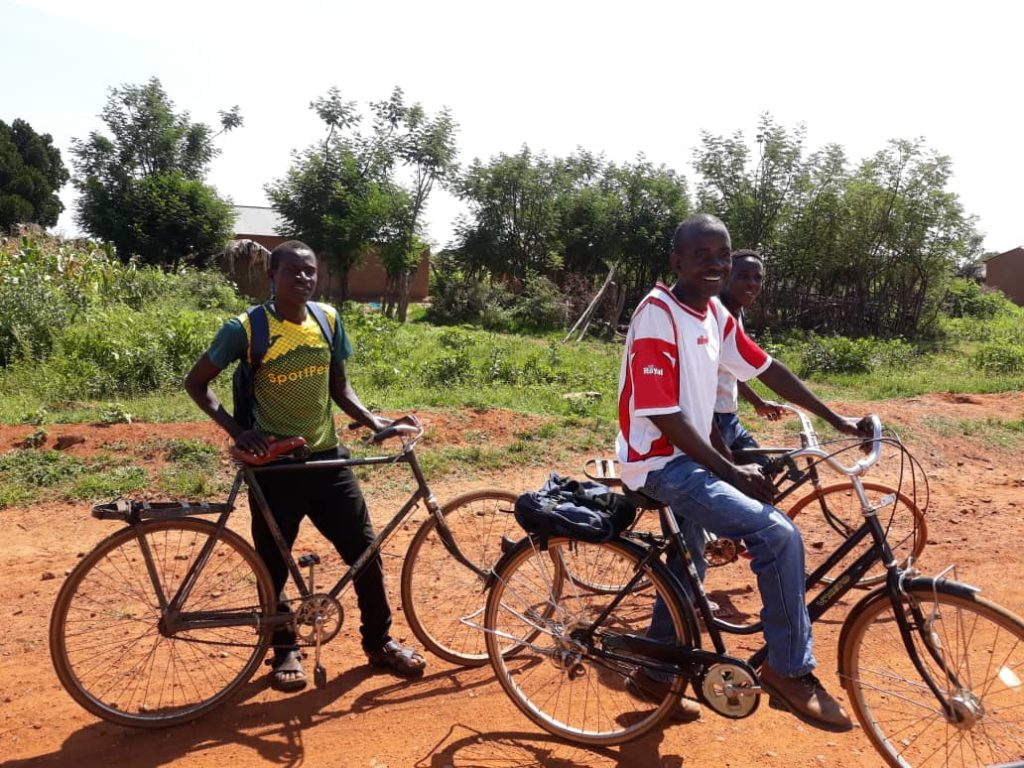 Boys ride bicycles provided by JSI in Tanzania.