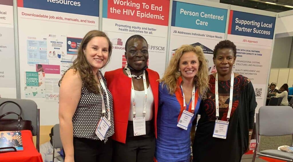 4 women pose at a conference