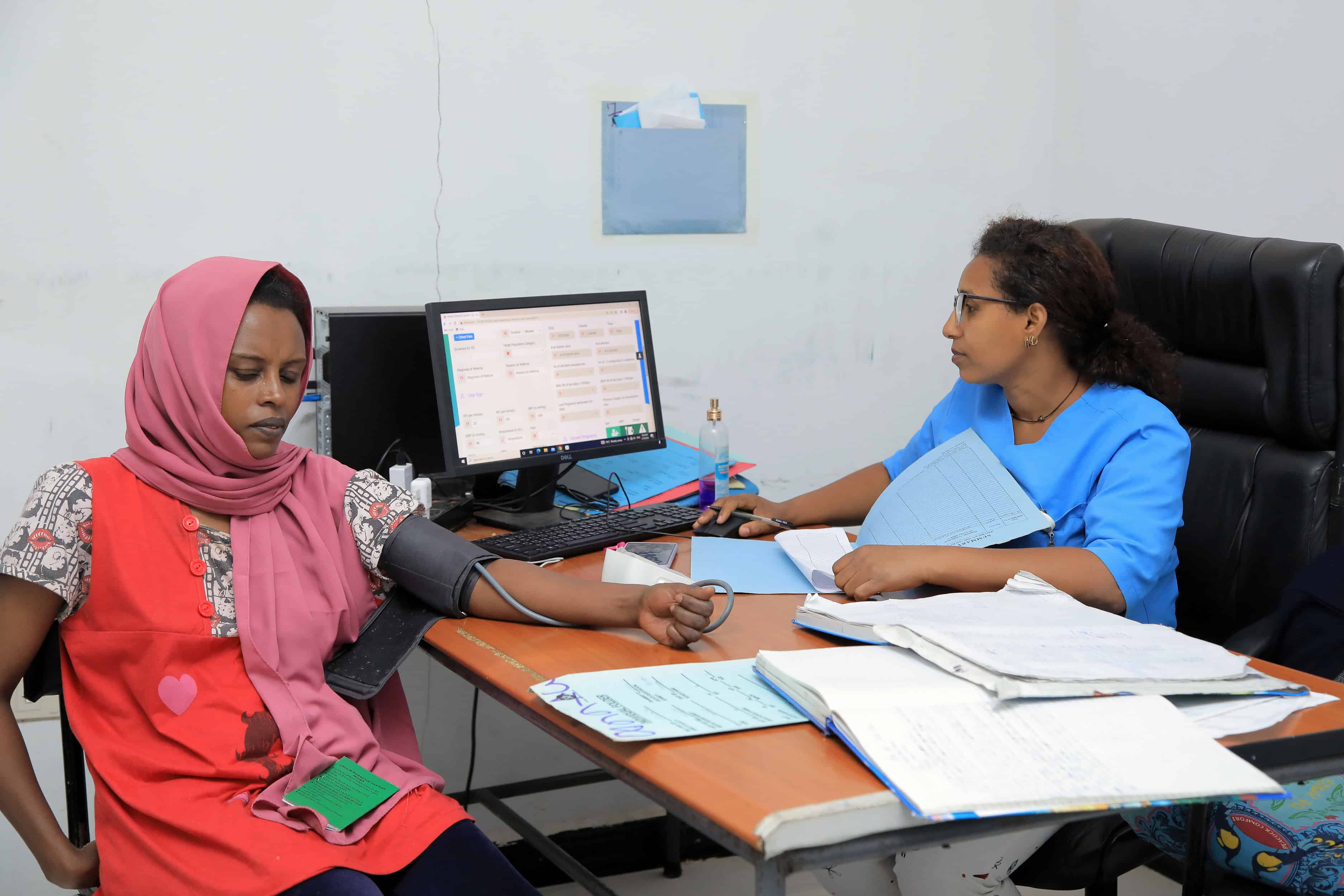 Health worker Amina Tariku examines a patient at the Abinet Health Center in Lideta Subcity, Addis Ababa.