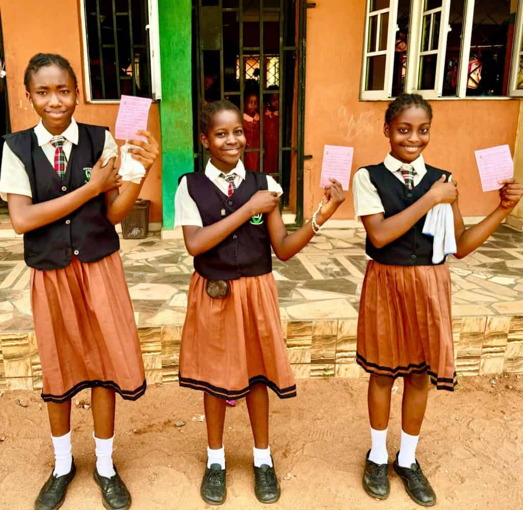 School girls in Edo State proudly display their vaccination cards after receiving the HPV Vaccine.