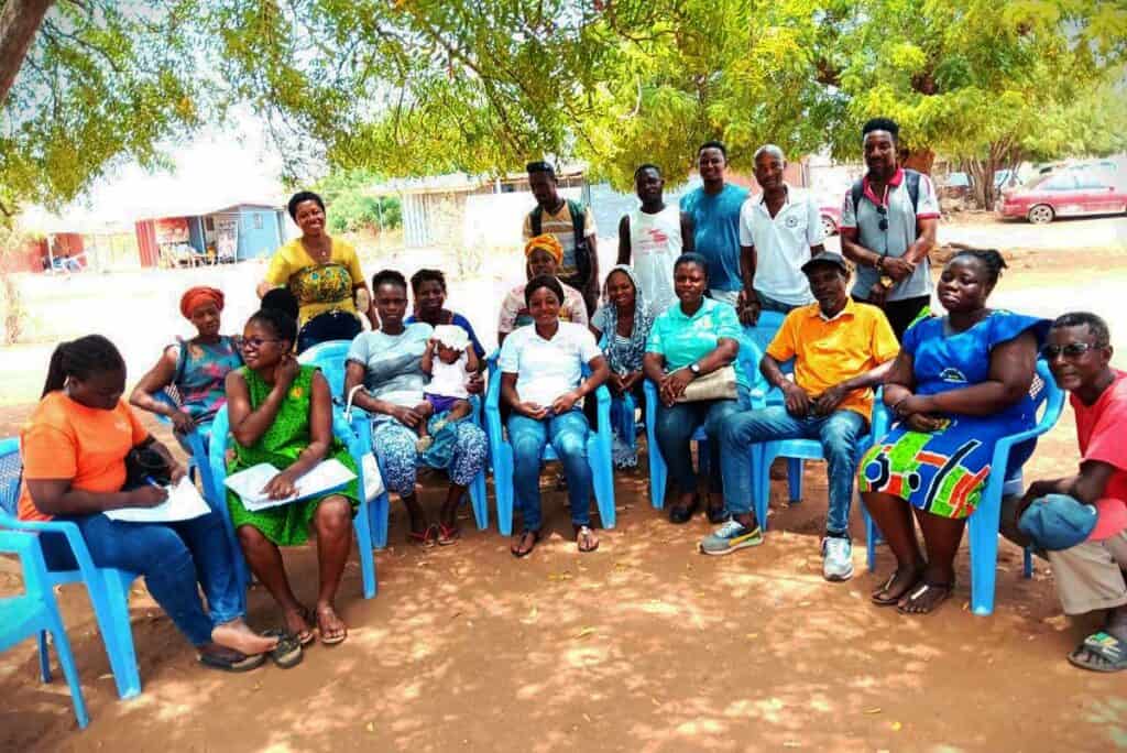 A female nurse (far left) poses with community members after a discussion on the importance of immunisation.