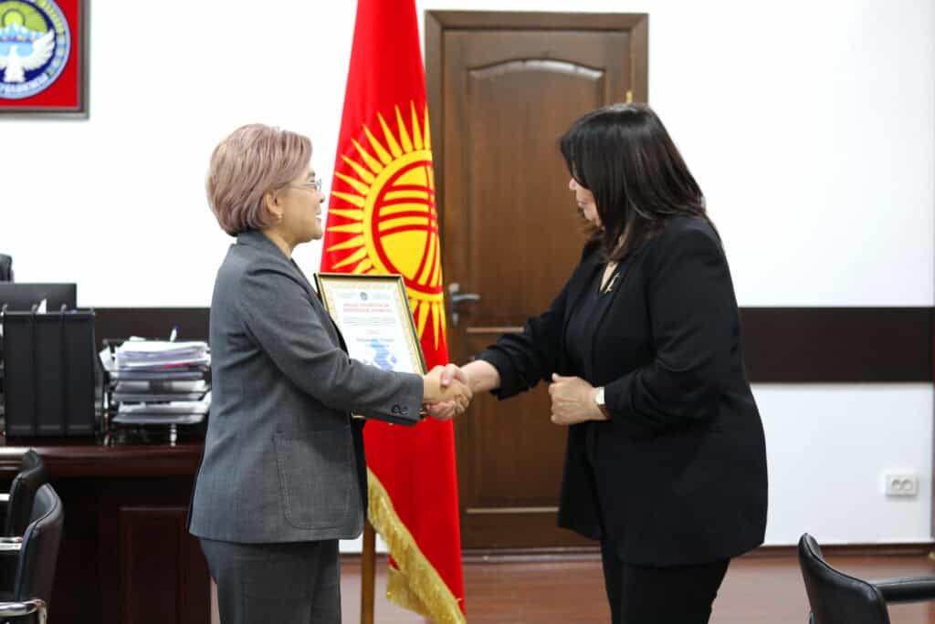 Ainura Ibraimova, chief of party of the USAID Cure Tuberculosis 2 Activity accepts the letter of recognition.