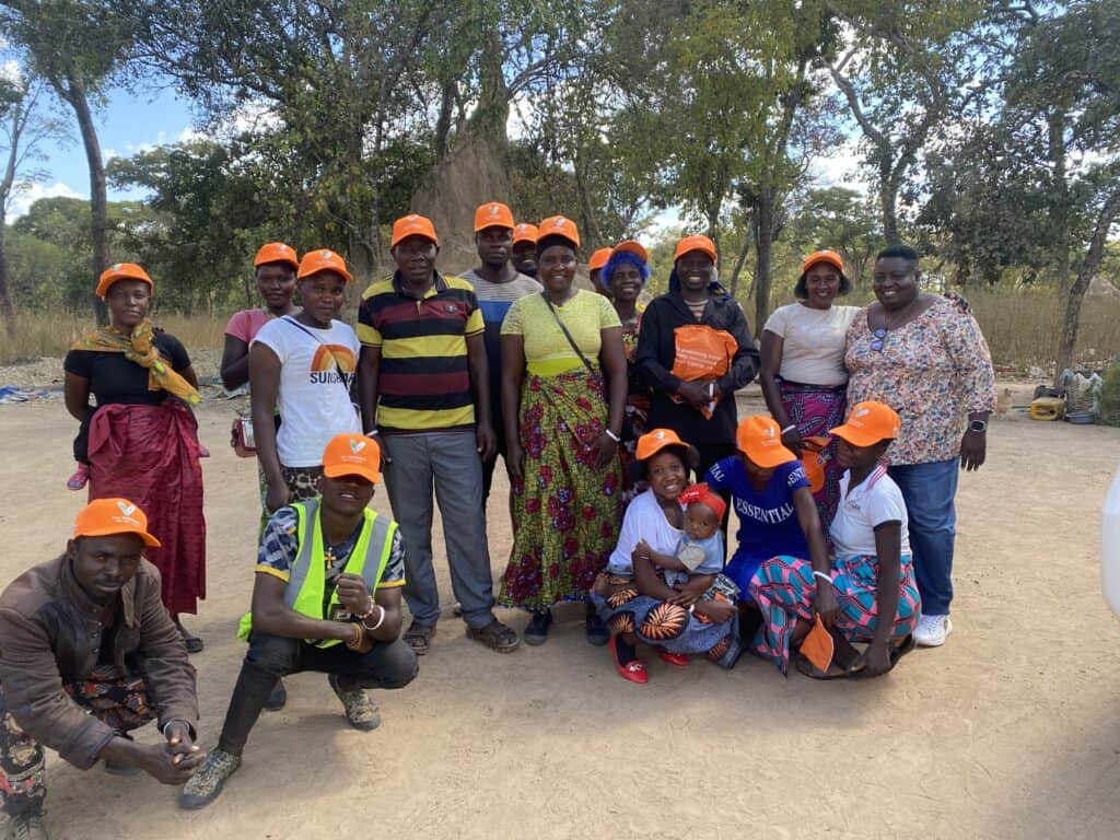 A group of people in Zambia pose for a photo together.