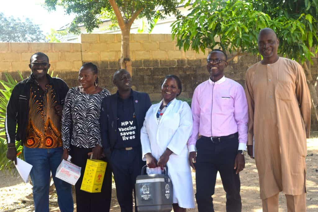 JSI and partner staff with healthcare workers, including a nurse (second and fourth from left), after administering HPV vaccinations to students.