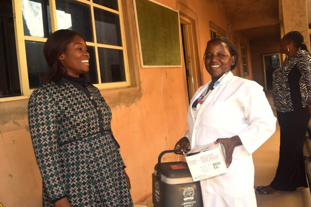 School principal Afodia Yusuf (left) in discussion with a nurse (right) before commencing HPV vaccination for students. Credit: Richard Adupong, JSI