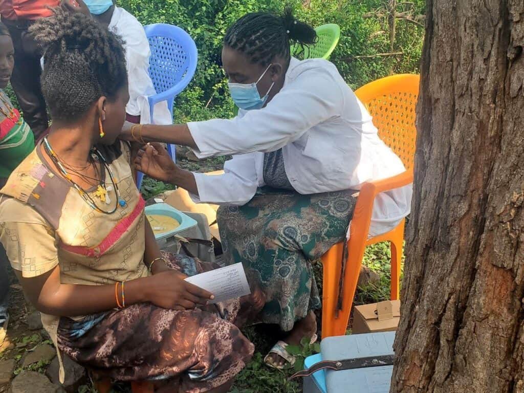 A health care worker vaccinates an adolescent girl during an outreach in Derashe woreda, South Ethiopia.